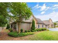 Lovely view of this single Gathering home featuring mature landscaping, neutral siding, and manicured lawn at 325 Ridge Hill Cir # 3, Marietta, GA 30064