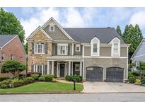 Charming two-story home featuring a stone facade, shingle siding, a two-car garage and manicured landscaping at 1075 Bluffhaven Way Northeast Ne Way, Atlanta, GA 30319