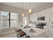 Bright eat-in kitchen with white cabinets, stainless steel appliances, and marble floors at 2030 Main Nw St # 205, Atlanta, GA 30318