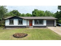 Charming single-story home with neutral paint, dark trim and a red front door at 5 Citation Ct, Ellenwood, GA 30294