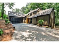 Stunning exterior view of modern home with attached garage and lush landscaping at 2189 Cedar Forks Dr, Marietta, GA 30062