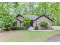 Charming single-story home featuring mature trees and meticulously maintained landscaping at 5930 Bridle Dr, Cumming, GA 30028