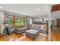 Bright living room featuring hardwood floors and open floor plan to the modern kitchen at 2720 Birchwood Sw Way, Marietta, GA 30060
