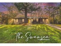Charming single-story home with a well-manicured lawn and inviting yellow front door at 2760 Swansea Ct, College Park, GA 30349