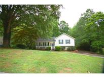 Charming home featuring a well-manicured lawn and beautiful landscaping, surrounded by lush greenery at 188 Thornbrooke Dr, Hiram, GA 30141