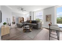 Comfortable living room showcasing contemporary design, hardwood floors, large windows, and a ceiling fan at 57 Forsyth Nw St # 6A, Atlanta, GA 30303