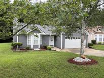 Charming home featuring a well-manicured front yard and a convenient attached one-car garage at 2529 Feathertree Ln, Lawrenceville, GA 30044