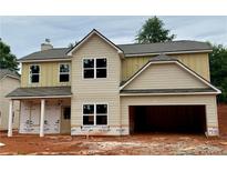 New two-story home featuring neutral siding, a two-car garage, and a covered front porch at 488 Charleston Pl, Villa Rica, GA 30180