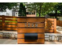 Charming home exterior featuring a crafted wooden address display with a black mailbox at 1558 Line St, Decatur, GA 30032