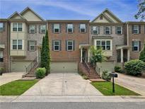 Charming brick townhome with well-manicured landscaping, a private garage, and inviting front entrance at 3729 Inglewood Ne Way, Atlanta, GA 30319