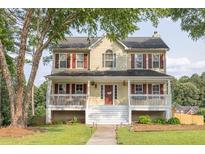 Charming two-story home with a welcoming front porch and well-manicured lawn at 422 Inwood Trail Trl, Lawrenceville, GA 30043