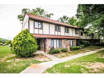 Inviting two-story townhome boasts charming brick accents and a well-manicured lawn at 1200 Ashborough Se Ter # A, Marietta, GA 30067