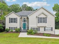 Charming two-story home with manicured lawn, stone accents, and a welcoming entrance at 4005 Greentree Ct, Douglasville, GA 30135
