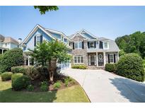 Charming two-story home featuring stone accents, manicured landscaping, and a welcoming front entrance at 5513 Lavender Farms Rd, Powder Springs, GA 30127