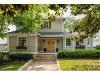 Charming two-story home with stone steps leading to a lovely entry and surrounded by lush landscaping at 178 Mayson Ne Ave, Atlanta, GA 30307