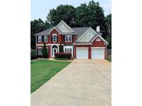 Charming two-story brick home with a well-manicured lawn and a spacious two-car garage at 1991 Westover Nw Ln, Kennesaw, GA 30152