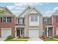 Charming brick townhome featuring a one-car garage and a neatly landscaped front yard at 2357 Heritage Park Nw Cir # 17, Kennesaw, GA 30144