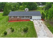 Charming brick home with well-manicured lawn, featuring an attached two-car garage at 5488 Janice Ln, Stone Mountain, GA 30087
