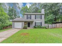 Charming two-story home featuring a manicured lawn and a convenient one-car garage at 3130 Glen Knolls Ct, Alpharetta, GA 30022