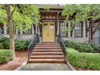 Inviting front entryway with brick stairs, stone accents, and bright yellow door at 345 Glen Iris Ne Dr # 3, Atlanta, GA 30312