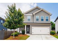 Charming two-story home with gray siding, well-manicured lawn and a two-car garage, perfect for a Gathering at 382 Winston Circle Cir, Canton, GA 30114