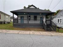 Charming bungalow with a covered front porch and freshly painted trim at 8 Hazel St, Porterdale, GA 30014