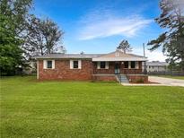 Charming brick home with a well-maintained front yard and inviting curb appeal at 145 Washington St, Mcdonough, GA 30253