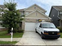 Charming two-story home with a two car garage and a well-manicured lawn at 102 Daisy Cir, Mcdonough, GA 30252