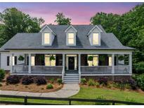 Charming front porch and manicured landscaping enhance the curb appeal of this inviting home at 1280 Trinity Church Rd, Canton, GA 30115