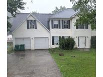 Two-story home with attached two-car garage, vinyl siding and black shutters at 3679 Seabass Rd, Decatur, GA 30034
