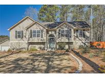 Charming home featuring a well-manicured front yard, stone accents and welcoming entrance at 13 Cliff Ct, Villa Rica, GA 30180