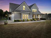 Charming two-story home featuring a well-manicured lawn and inviting covered porch at 220 Alcovy Reserve Way, Covington, GA 30014