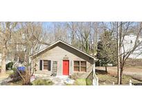 Charming single-Gathering home featuring a red front door, well-maintained lawn, and classic architectural details at 2363 Paul Nw Ave, Atlanta, GA 30318