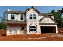 New two-story home featuring a covered entrance, large windows, and an attached two-car garage in a suburban neighborhood at 492 Charleston Pl, Villa Rica, GA 30180