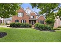 Charming two-story brick home with well-manicured lawn and lush landscaping at 2738 Riderwood Ne Ln, Marietta, GA 30062
