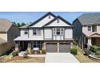 Charming two-story home featuring a gray exterior, stone accents, and a well-manicured front yard at 5470 Beaver Ridge Dr, Cumming, GA 30040