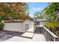 The exterior shows a house with a two-car garage, a wooden deck, and metal railings at 3985 Loch Highland Ne Pass, Roswell, GA 30075