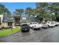 Exterior view of the condominium complex with multiple parking spaces available for residents and visitors at 123 Maison Nw Pl, Atlanta, GA 30327