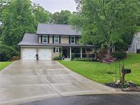 Charming two-story home featuring a spacious two-car garage and a welcoming covered front porch at 2263 Hill Creek Way, Marietta, GA 30062