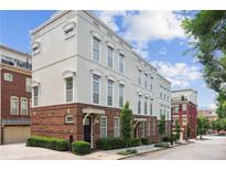 Charming townhome with brick accents, large windows, and manicured landscaping at 306 Masons Row, Marietta, GA 30060