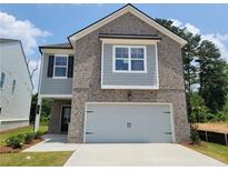 Charming two-story home with brick and siding exterior and a two-car garage at 45 Avian Way, Auburn, GA 30011