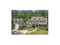 Beautiful two-story home with a detached garage, a lush green lawn, and mature trees at 193 Stonegate Trl, Carrollton, GA 30116