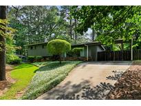 Charming single-story home with a well-manicured lawn and a covered parking area at 3408 Chestnut Dr, Doraville, GA 30340