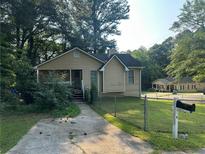 Charming one-story home with a black roof and an inviting front porch at 6195 Short St, Canton, GA 30114