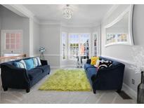 Bright living room with two sofas, plush rug, and a bay window offering abundant natural light at 1286 Creekside Se Ter, Smyrna, GA 30082