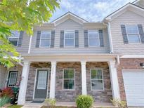 Charming townhome with stone facade, inviting entrance, and well-maintained landscaping at 1531 Iris Walk, Jonesboro, GA 30238
