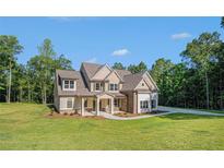 Inviting exterior showcasing a well-manicured lawn and a charming craftsman-style home design at 157 West Lake Blvd, Carrollton, GA 30116