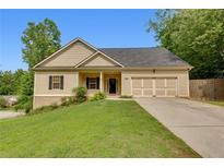 Charming home features a manicured lawn and a two-car garage at 3792 Refinement Way, Douglasville, GA 30135