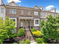 Charming brick townhome with well-manicured landscaping and a welcoming entrance at 1094 Township Sq, Alpharetta, GA 30022