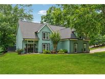 Charming home with a beautiful front yard, well-manicured lawn, and a welcoming entrance at 1206 Red Fox Cir, Woodstock, GA 30188